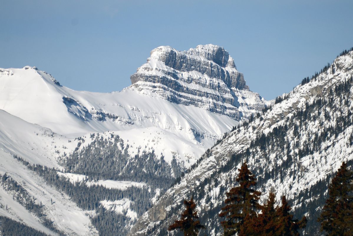 22C Pilot Mountain Glow At Mid-Day From Bow River Bridge In Banff In Winter